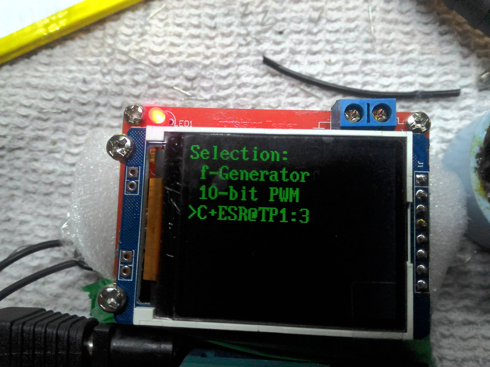 Скриншот меню тестера компонентов (зелёный текст на чёрном): «Selection: / f-Generator / 10-bit PWM / >C+ESR@TP1:3»